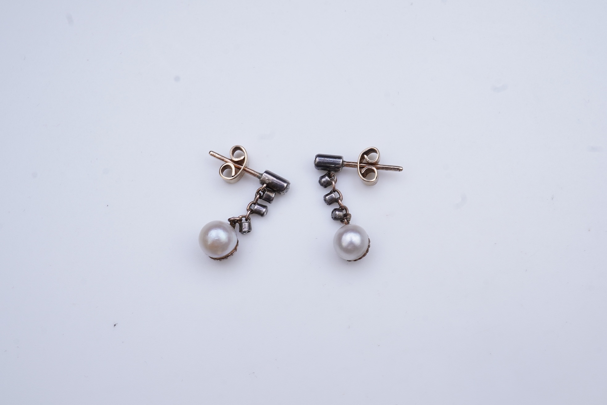 A pair of cultured pearl and diamond earrings, early 20th century and later